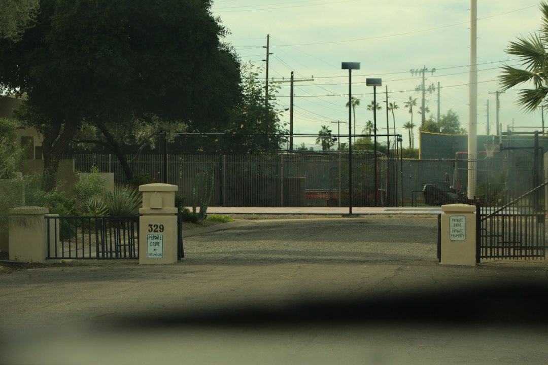 A private drive entrance with metal gates and signs reading private drive